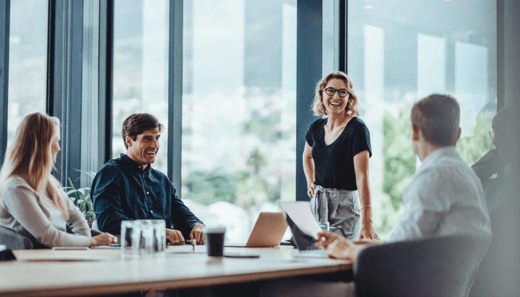 Office Colleagues Having Casual Discussion During Meeting In Conference Room.