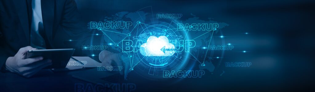Businessman using a tablet with a digital cloud icon surrounded by the word “BACKUP” and connected cloud symbols, representing cloud data backup and cybersecurity technology.