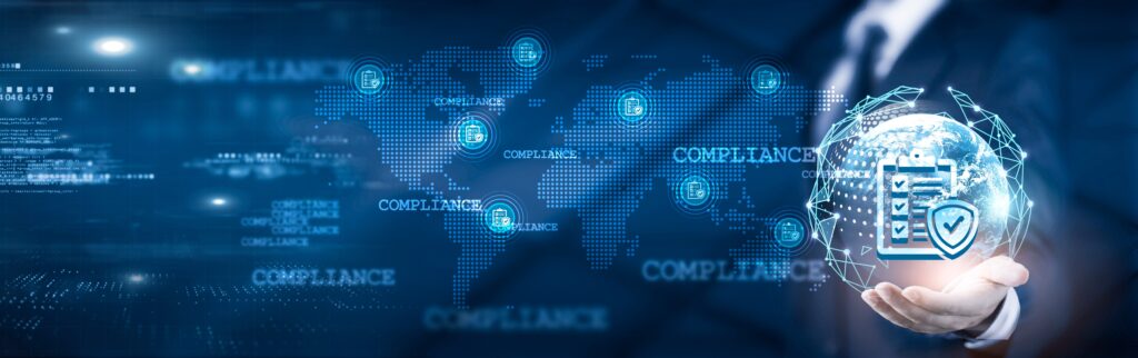 Businessman holding digital globe with compliance icons, representing global data protection and regulatory standards.