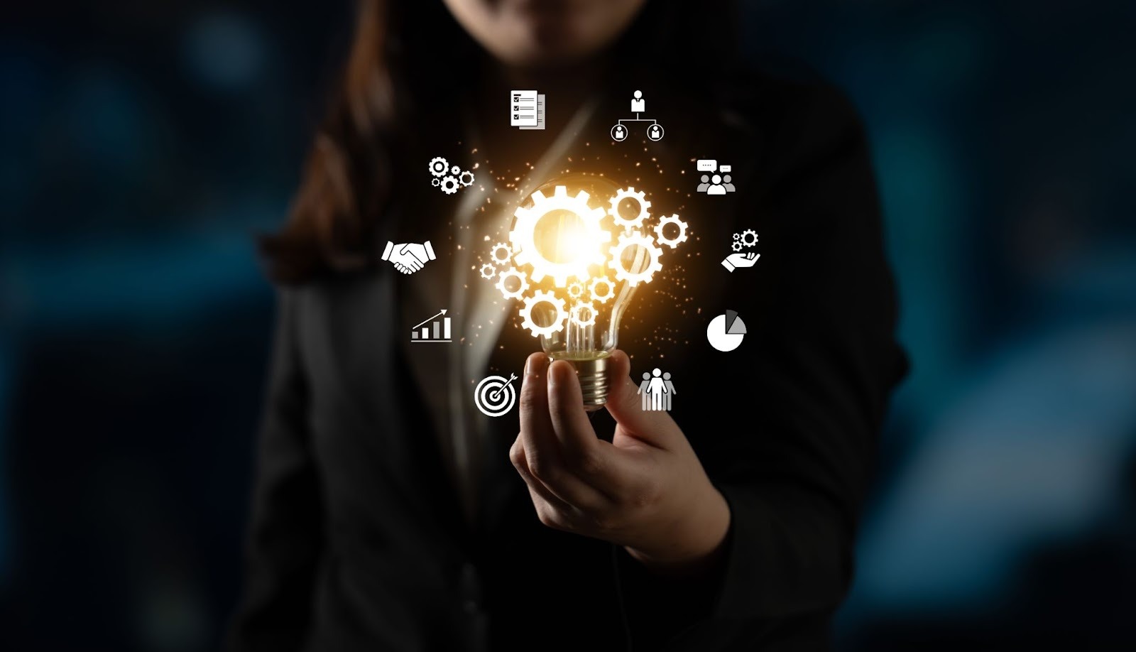 A person in a suit holds a glowing lightbulb surrounded by floating process icons