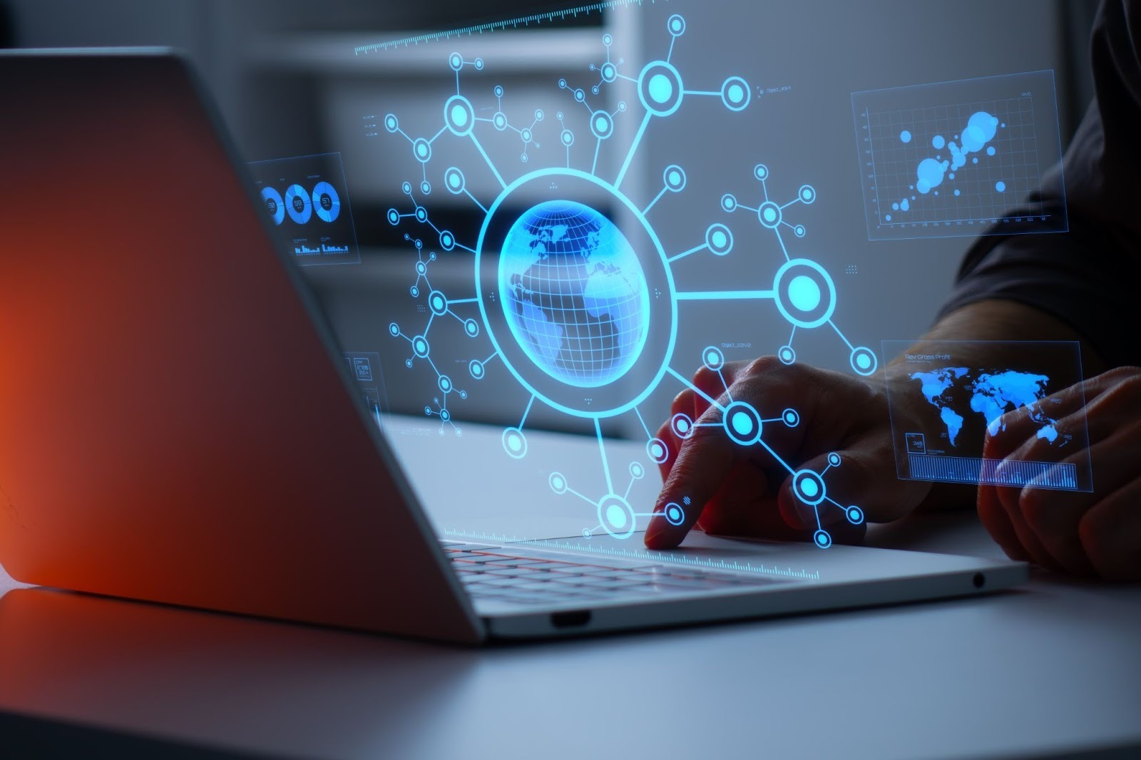 A person uses a laptop with holographic digital interfaces, including a globe and network icons.