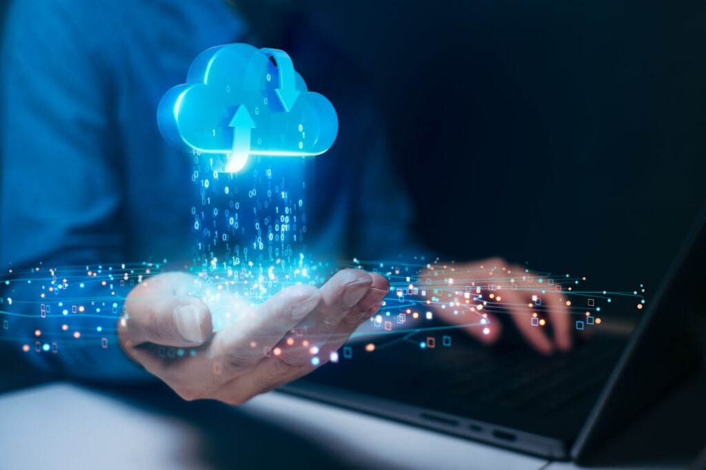 A person holds a glowing digital cloud above their palm
