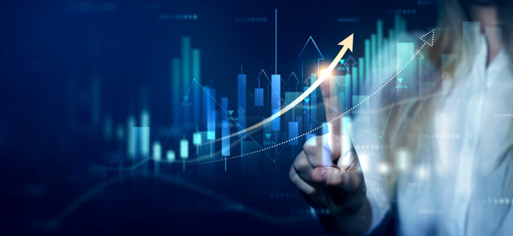 A person interacts with a digital screen showing rising graphs and an upward arrow